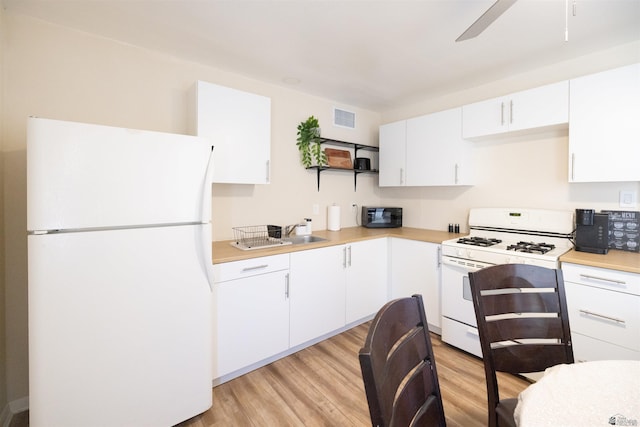 2508 S 7th Ave, Yuma, AZ 85364 - kitchen featuring white appliances, light countertops, light wood-style flooring, open shelves, and white cabinetry