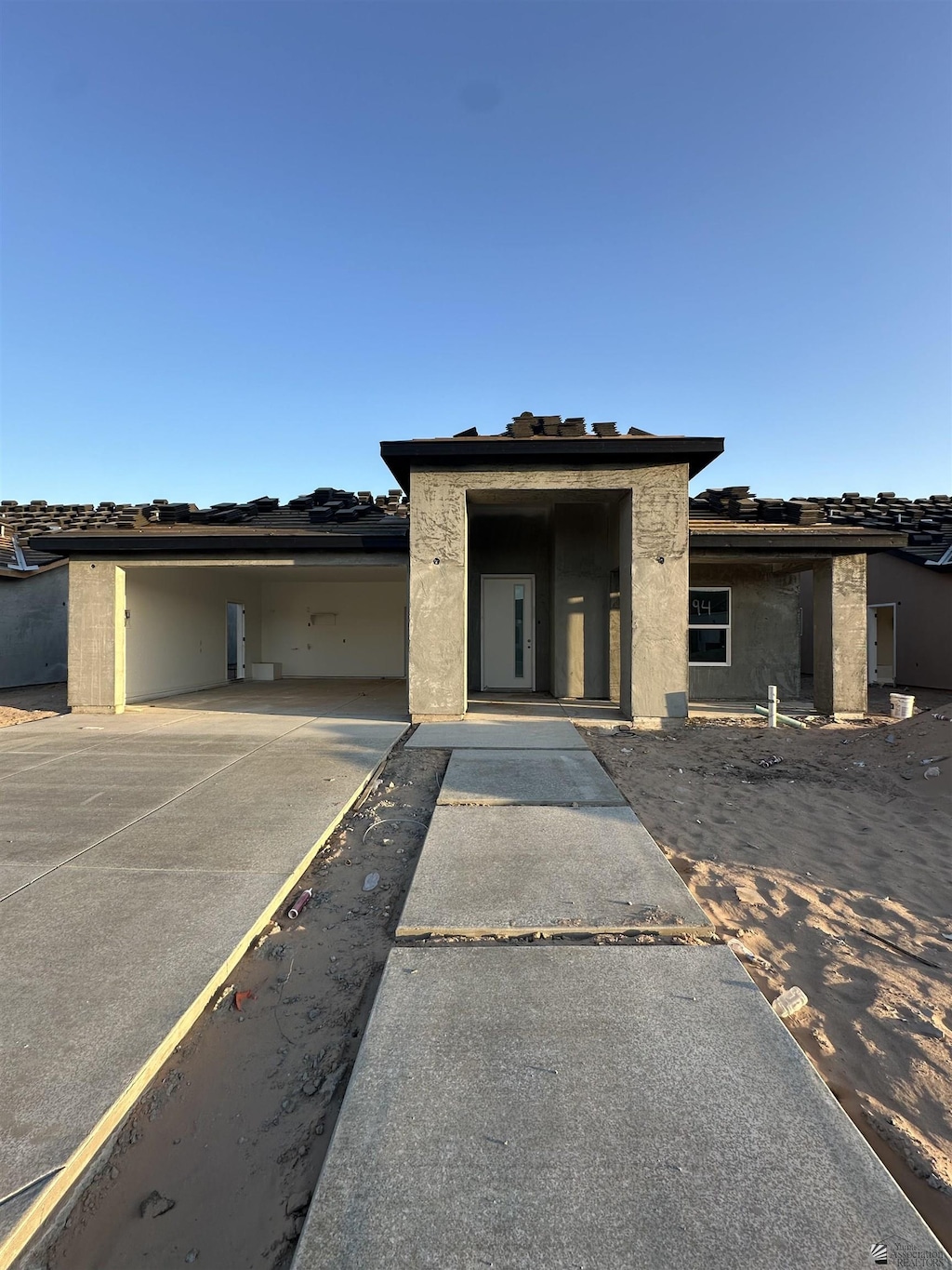 7961 E 34th Pl, Yuma, AZ 85365 - view of front facade with concrete driveway, a carport, and stucco siding