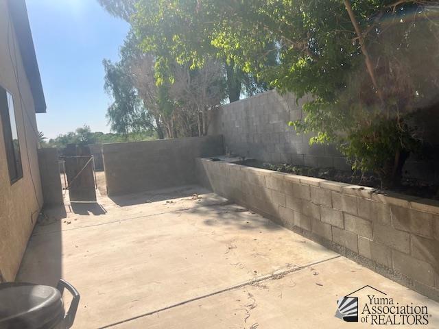 1432 S Sunset Dr, Yuma, AZ 85364 - fenced backyard featuring a patio