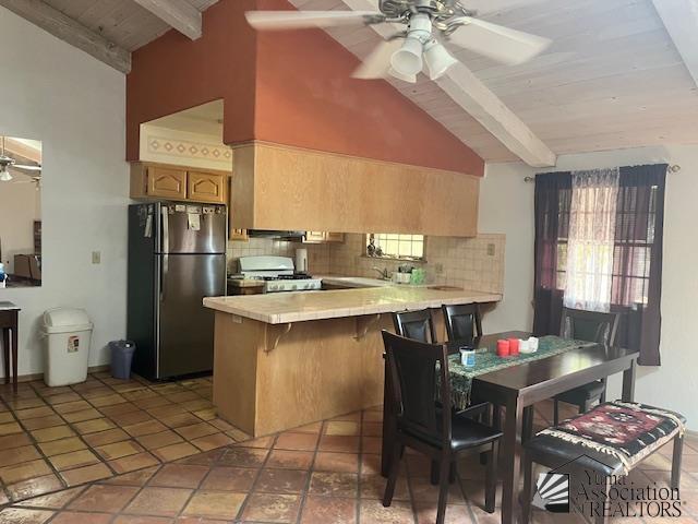 1432 S Sunset Dr, Yuma, AZ 85364 - kitchen featuring freestanding refrigerator, a ceiling fan, range, a peninsula, and tasteful backsplash