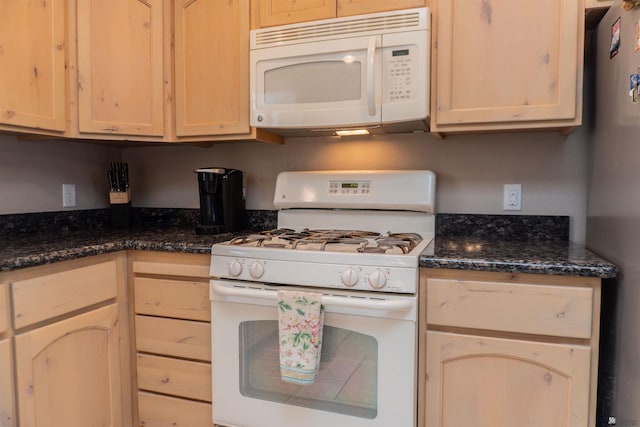 11519 E Del Verde St, Yuma, AZ 85367 - kitchen featuring white appliances, light brown cabinetry, and dark stone counters