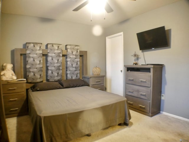 bedroom featuring a ceiling fan, baseboards, and light carpet