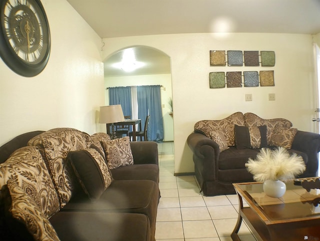 living room with light tile patterned flooring and arched walkways