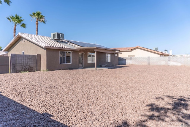 6351 E 41st St, Yuma, AZ 85365 - rear view of property featuring cooling unit, stucco siding, a fenced backyard, solar panels, and a patio area
