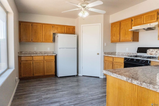 6351 E 41st St, Yuma, AZ 85365 - kitchen featuring freestanding refrigerator, under cabinet range hood, black gas stove, ceiling fan, and dark wood-style floors