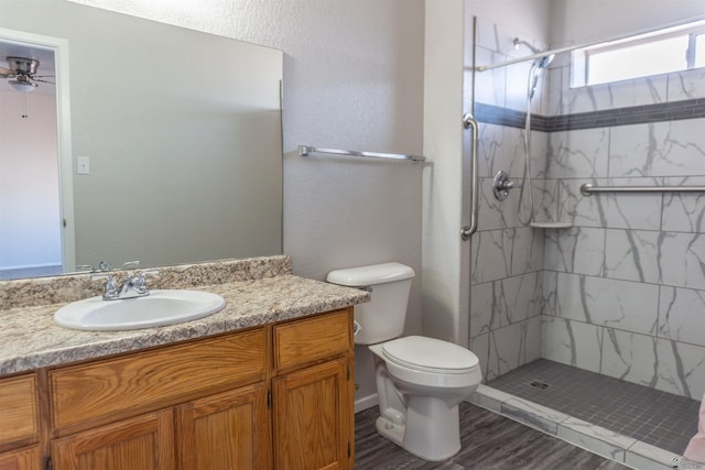 6351 E 41st St, Yuma, AZ 85365 - full bathroom with a stall shower, vanity, toilet, wood finished floors, and ceiling fan