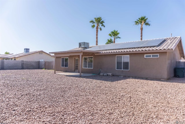 6351 E 41st St, Yuma, AZ 85365 - rear view of property featuring roof mounted solar panels, a patio area, stucco siding, a fenced backyard, and central AC