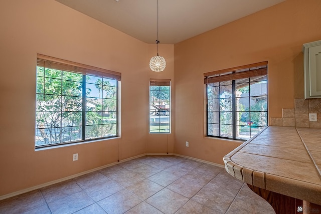 unfurnished dining area with plenty of natural light and light tile patterned floors