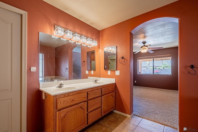 bathroom with tile patterned floors, vanity, and ceiling fan