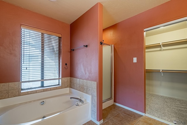 bathroom with tile patterned flooring, a wealth of natural light, and independent shower and bath