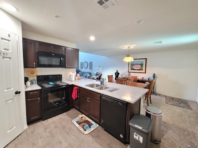 kitchen with black appliances, sink, hanging light fixtures, kitchen peninsula, and dark brown cabinets