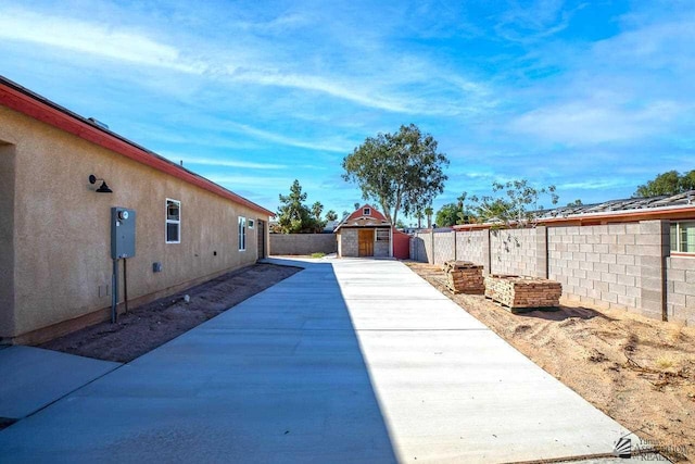 13459 E 43rd Ln, Yuma, AZ 85367 - exterior space with a fenced backyard, a storage unit, a patio, and an outbuilding