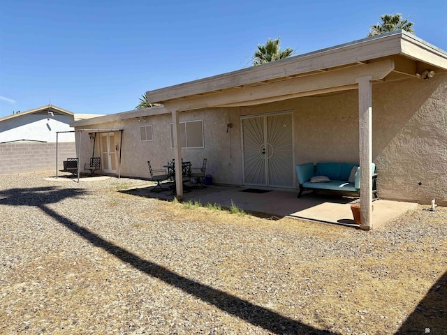 4447 W 14th Pl, Yuma, AZ 85364 - rear view of house with stucco siding and a patio area