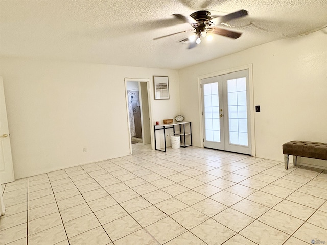 4447 W 14th Pl, Yuma, AZ 85364 - unfurnished room featuring a textured ceiling, a ceiling fan, french doors, and light tile patterned floors