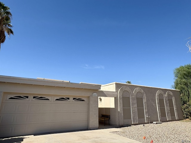 4447 W 14th Pl, Yuma, AZ 85364 - pueblo-style house featuring driveway and a garage
