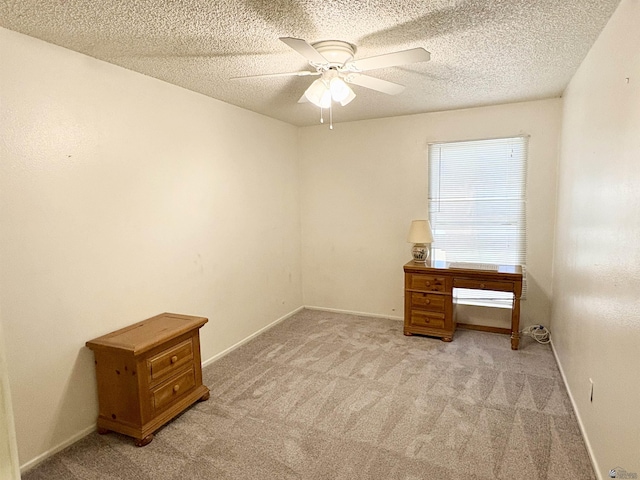 4447 W 14th Pl, Yuma, AZ 85364 - unfurnished bedroom featuring light carpet, a textured ceiling, and a ceiling fan