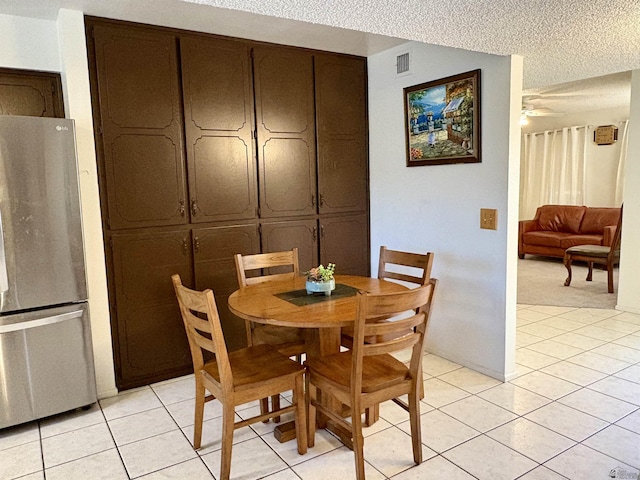 4447 W 14th Pl, Yuma, AZ 85364 - dining space featuring ceiling fan, light tile patterned flooring, and a textured ceiling