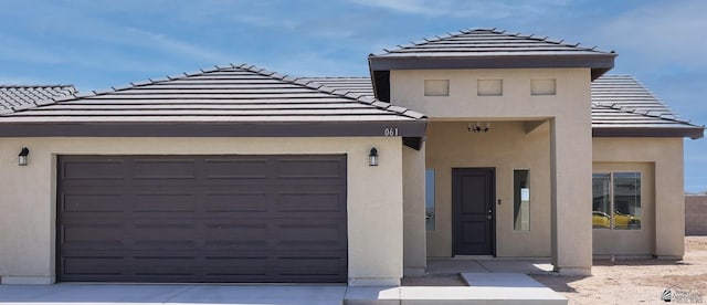 10802 E 45th Pl, Yuma, AZ 85367 - view of front facade featuring an attached garage, a tiled roof, stucco siding, and driveway