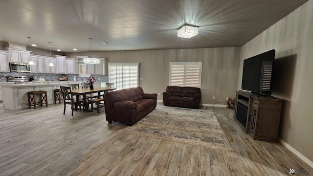 11569 Sonora St, Wellton, AZ 85356 - living room featuring light wood finished floors, baseboards, and a fireplace