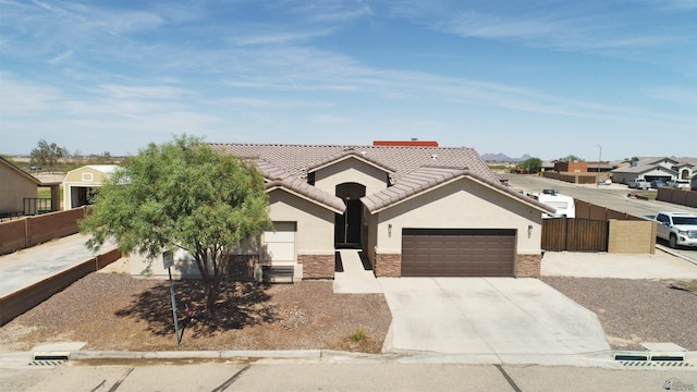 11569 Sonora St, Wellton, AZ 85356 - single story home with an attached garage, stucco siding, driveway, stone siding, and a residential view