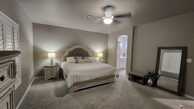 11569 Sonora St, Wellton, AZ 85356 - bedroom with arched walkways, carpet flooring, ensuite bath, baseboards, and a ceiling fan