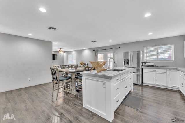 1428 W 15th St, Yuma, AZ 85364 - kitchen with stainless steel fridge with ice dispenser, a sink, recessed lighting, healthy amount of natural light, and white cabinetry
