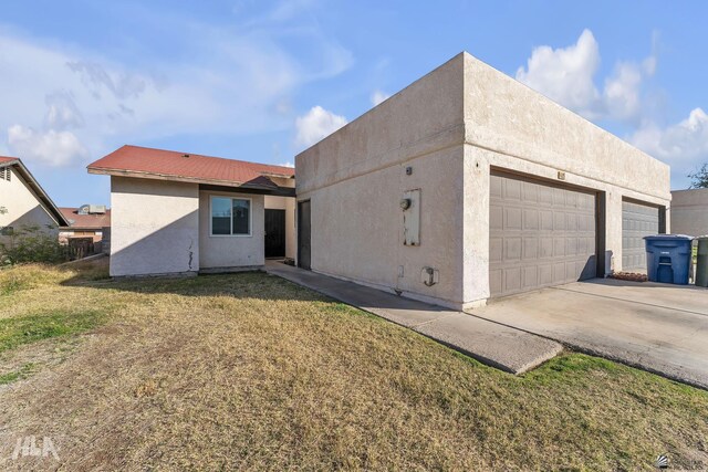 1428 W 15th St, Yuma, AZ 85364 - rear view of house with stucco siding and a lawn