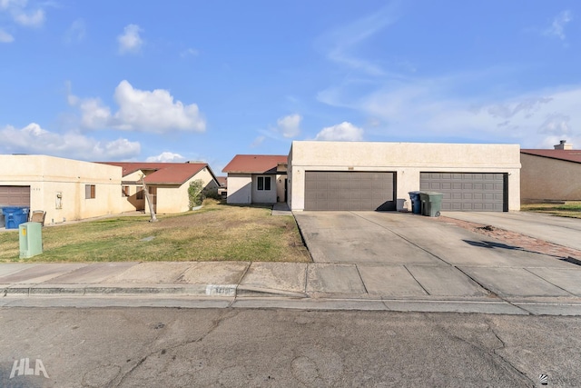 1428 W 15th St, Yuma, AZ 85364 - adobe home with driveway, a front yard, stucco siding, and a garage