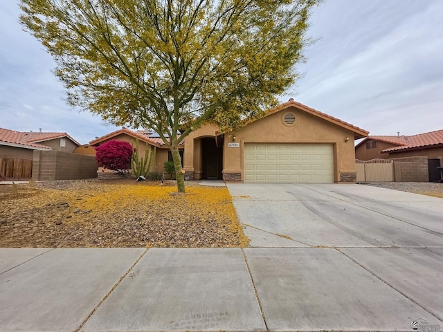 10791 S Sonora St, Yuma, AZ 85367 - view of front of house featuring a garage, stucco siding, driveway, and fence