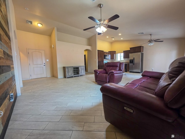 10791 S Sonora St, Yuma, AZ 85367 - living area featuring visible vents, a fireplace, ceiling fan, arched walkways, and vaulted ceiling