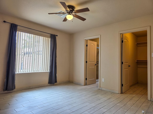 10791 S Sonora St, Yuma, AZ 85367 - unfurnished bedroom with baseboards, a spacious closet, ceiling fan, and light wood finished floors