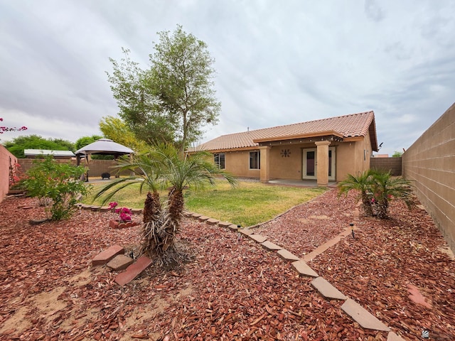10791 S Sonora St, Yuma, AZ 85367 - back of house with a gazebo, stucco siding, a fenced backyard, a patio area, and a tiled roof