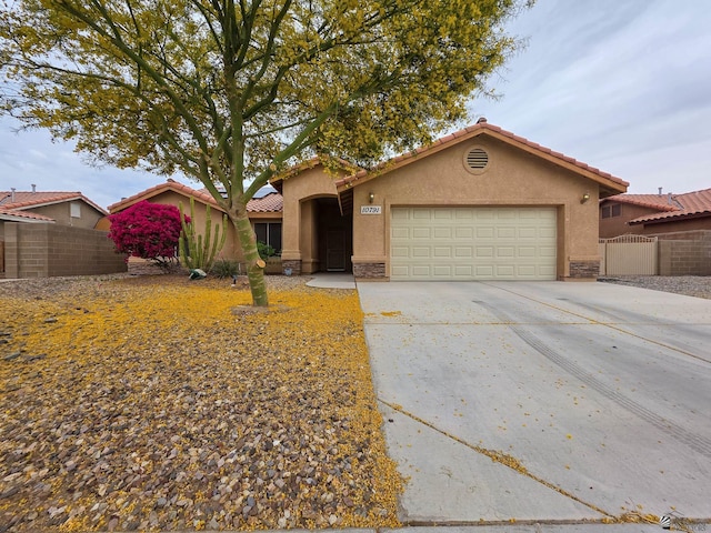 10791 S Sonora St, Yuma, AZ 85367 - view of front of home featuring an attached garage, stucco siding, and fence