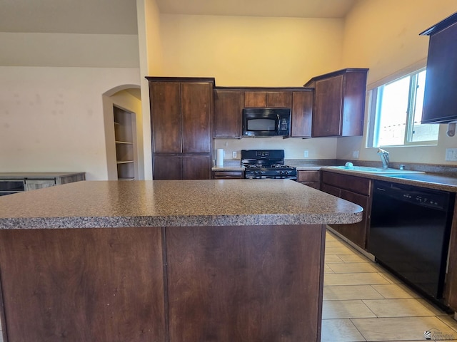 10791 S Sonora St, Yuma, AZ 85367 - kitchen with dark brown cabinetry, a center island, arched walkways, a sink, and black appliances