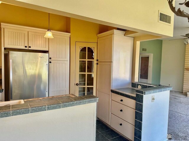 500 E Country Club Dr # 24, Yuma, AZ 85365 - kitchen with pendant lighting, visible vents, tile counters, and stainless steel refrigerator