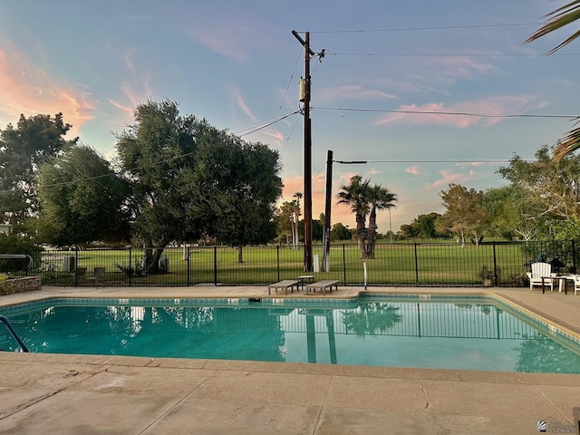 500 E Country Club Dr # 24, Yuma, AZ 85365 - pool at dusk with a patio, a community pool, a lawn, and fence