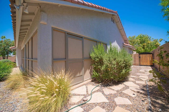 10388 S Fairway Loop, Yuma, AZ 85367 - view of home's exterior featuring a gate, stucco siding, and a tile roof