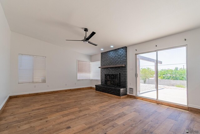 1087 W Palmcroft Dr, Yuma, AZ 85364 - unfurnished living room with wood finished floors, ceiling fan, a brick fireplace, and recessed lighting