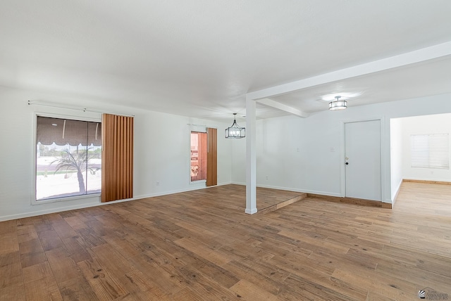 1087 W Palmcroft Dr, Yuma, AZ 85364 - unfurnished living room featuring a chandelier and wood finished floors