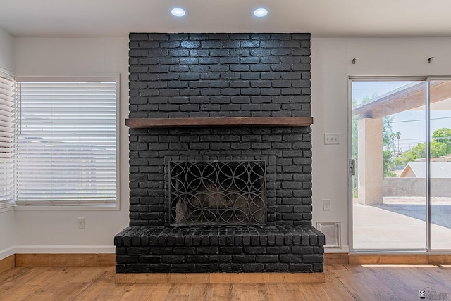 1087 W Palmcroft Dr, Yuma, AZ 85364 - detailed view of wood finished floors, a brick fireplace, and recessed lighting