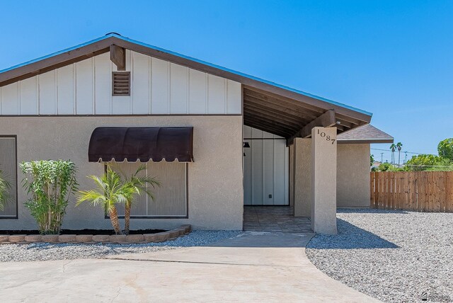1087 W Palmcroft Dr, Yuma, AZ 85364 - view of exterior entry featuring board and batten siding and stucco siding