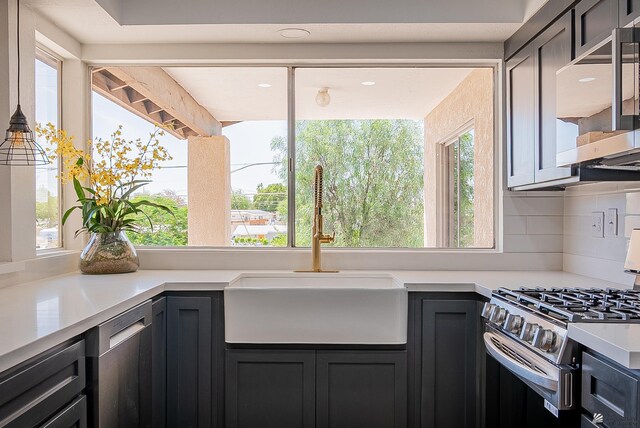 1087 W Palmcroft Dr, Yuma, AZ 85364 - kitchen with stainless steel appliances, light countertops, and tasteful backsplash