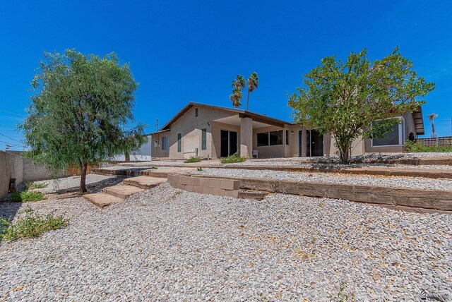 1087 W Palmcroft Dr, Yuma, AZ 85364 - rear view of house featuring stucco siding