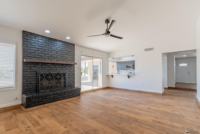 1087 W Palmcroft Dr, Yuma, AZ 85364 - unfurnished living room with ceiling fan, wood finished floors, a brick fireplace, and recessed lighting