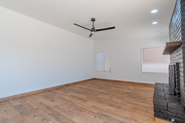 1087 W Palmcroft Dr, Yuma, AZ 85364 - unfurnished living room with a brick fireplace, a ceiling fan, light wood-style floors, and recessed lighting