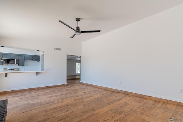 1087 W Palmcroft Dr, Yuma, AZ 85364 - unfurnished living room featuring ceiling fan, wood finished floors, and high vaulted ceiling