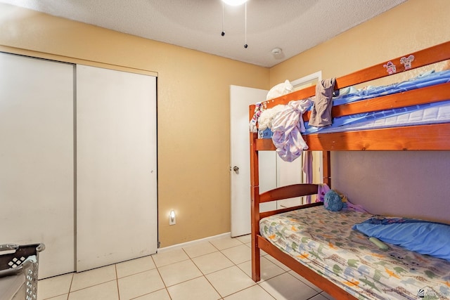 8678 E 25th St, Yuma, AZ 85365 - bedroom with a closet, tile patterned flooring, a ceiling fan, and baseboards