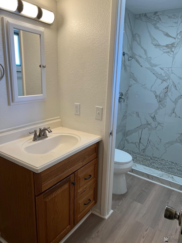 2514 W 21st St, Yuma, AZ 85364 - bathroom featuring vanity, toilet, a marble finish shower, and wood finished floors