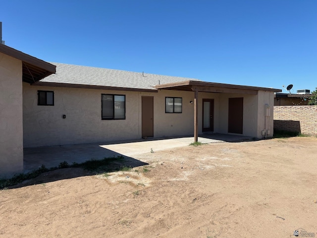 2514 W 21st St, Yuma, AZ 85364 - back of house featuring a patio, stucco siding, fence, and roof with shingles