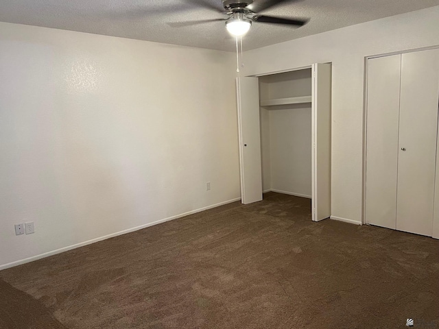 2514 W 21st St, Yuma, AZ 85364 - unfurnished bedroom featuring two closets, dark carpet, a ceiling fan, baseboards, and a textured ceiling